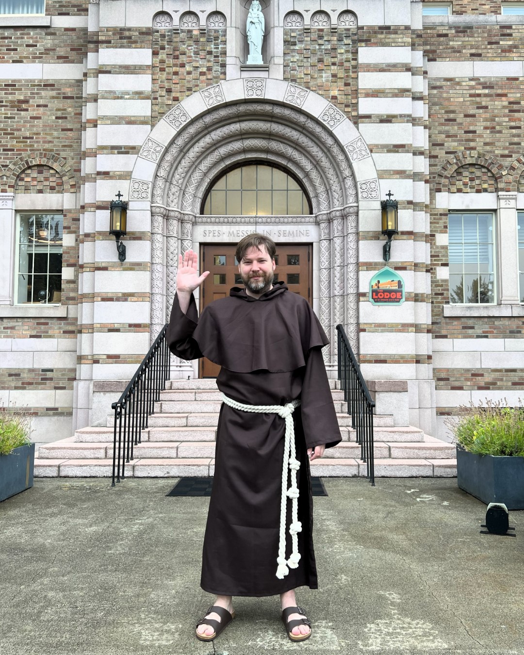 Brice in a Franciscan habit outside Saint Edward's Seminary